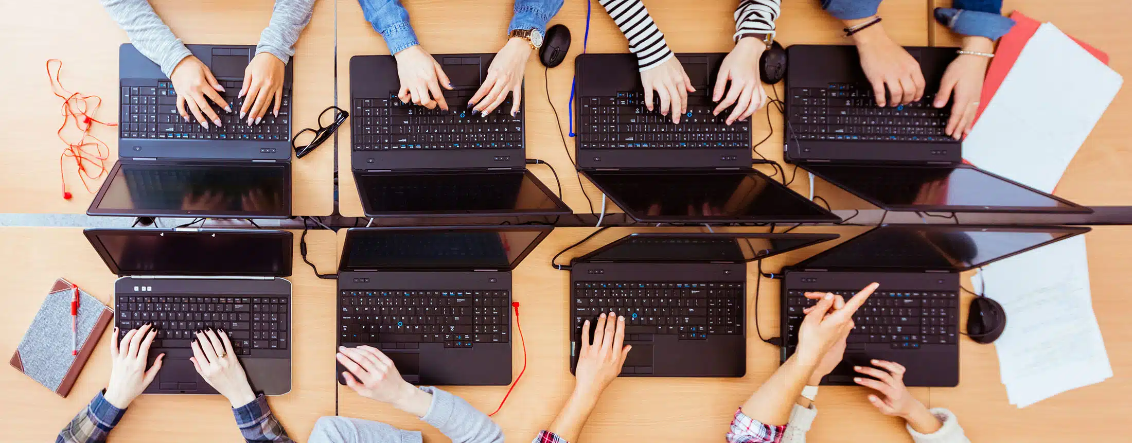 Girls in a computer lab typing on laptops